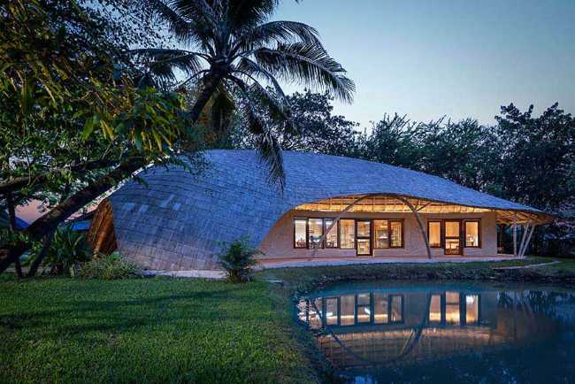 Architecture studio on water's edge. Organic temple of creativity