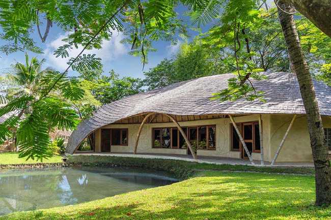 Architecture studio on water's edge. Organic temple of creativity