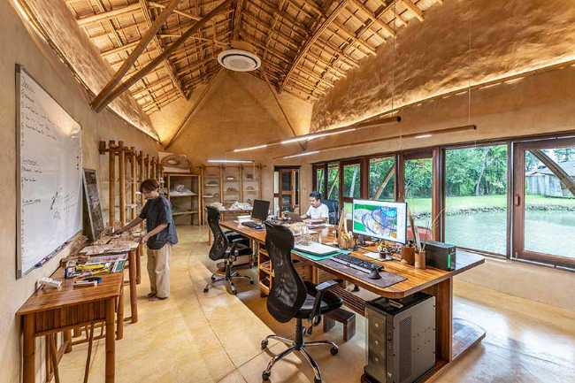 Architecture studio on water's edge. Organic temple of creativity