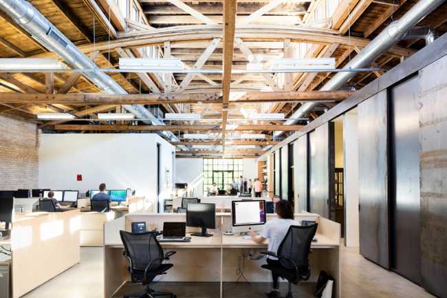 interior open space office with wooden desks