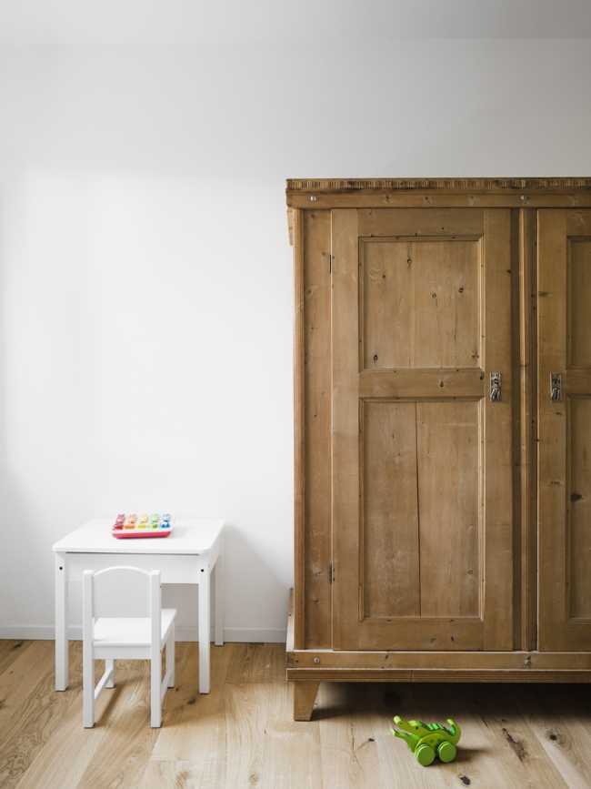 A wood wardrobe completes the minimal furniture