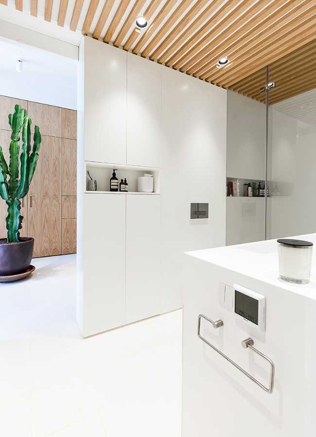 bathroom floor and white furniture with wooden ceiling