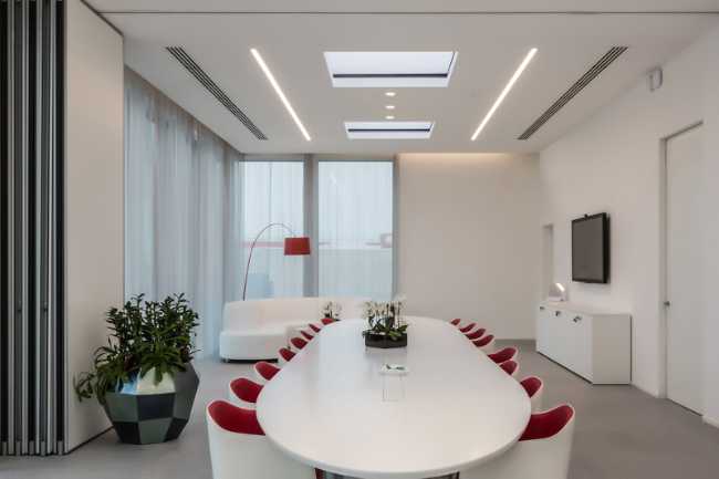 The meeting room in white tones and red seats