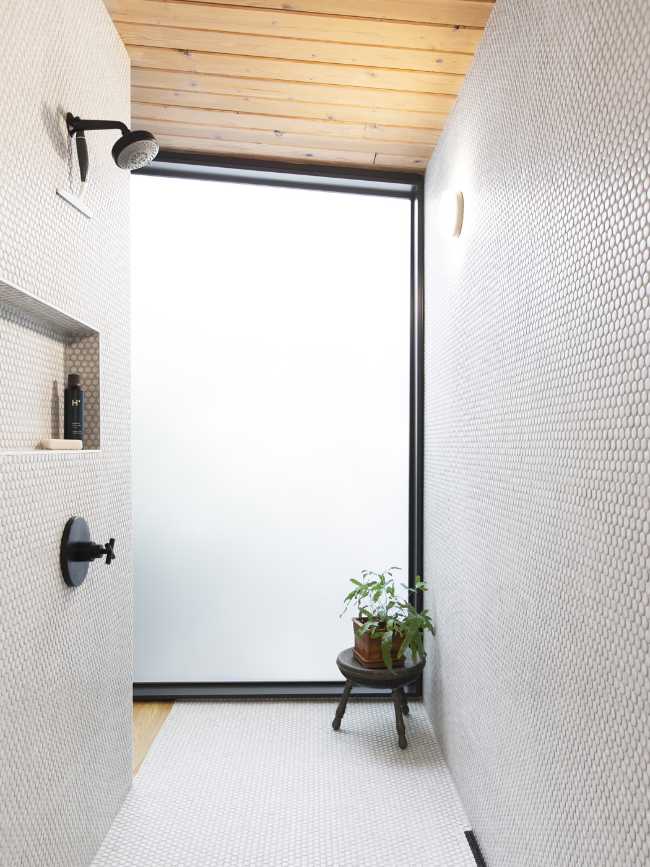 The shower covered in mosaic with frosted glass