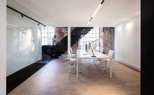 Minimal meeting room in contrast with the existing walls of the church