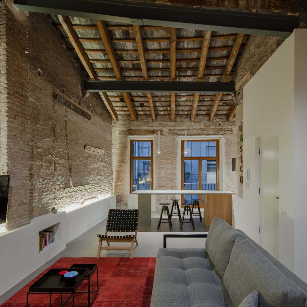 The interior preserves the wooden beams and the exposed brick walls