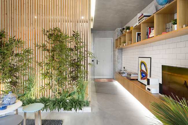 A wooden piece of furniture runs throughout the entrance wall