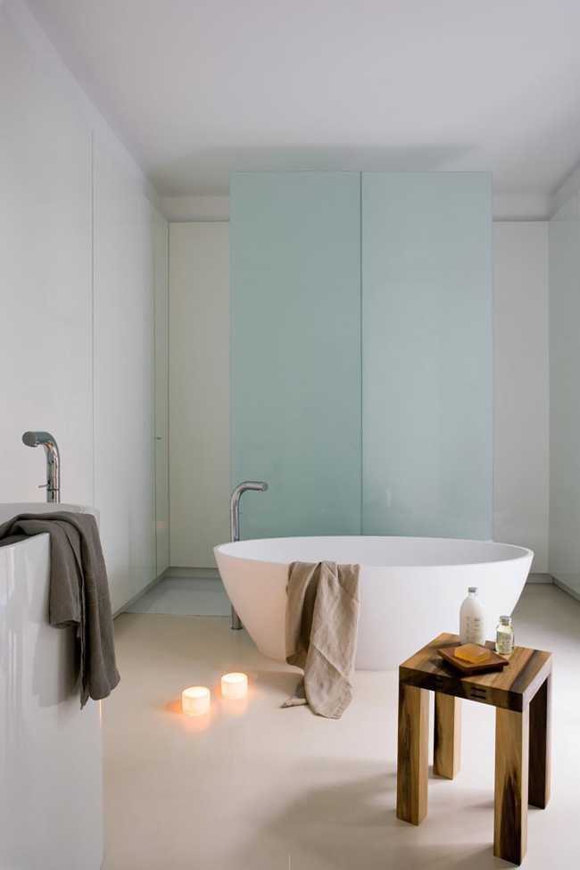 White glass and wood identify the bathroom with the large central basin