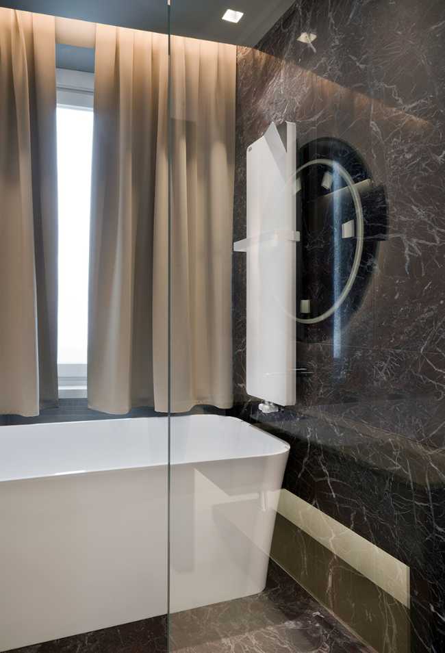 full glass bath and designer heated towel rail