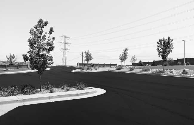 Black and white photograph of a mall parking