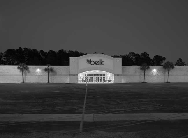 Night lights illuminate a shopping center