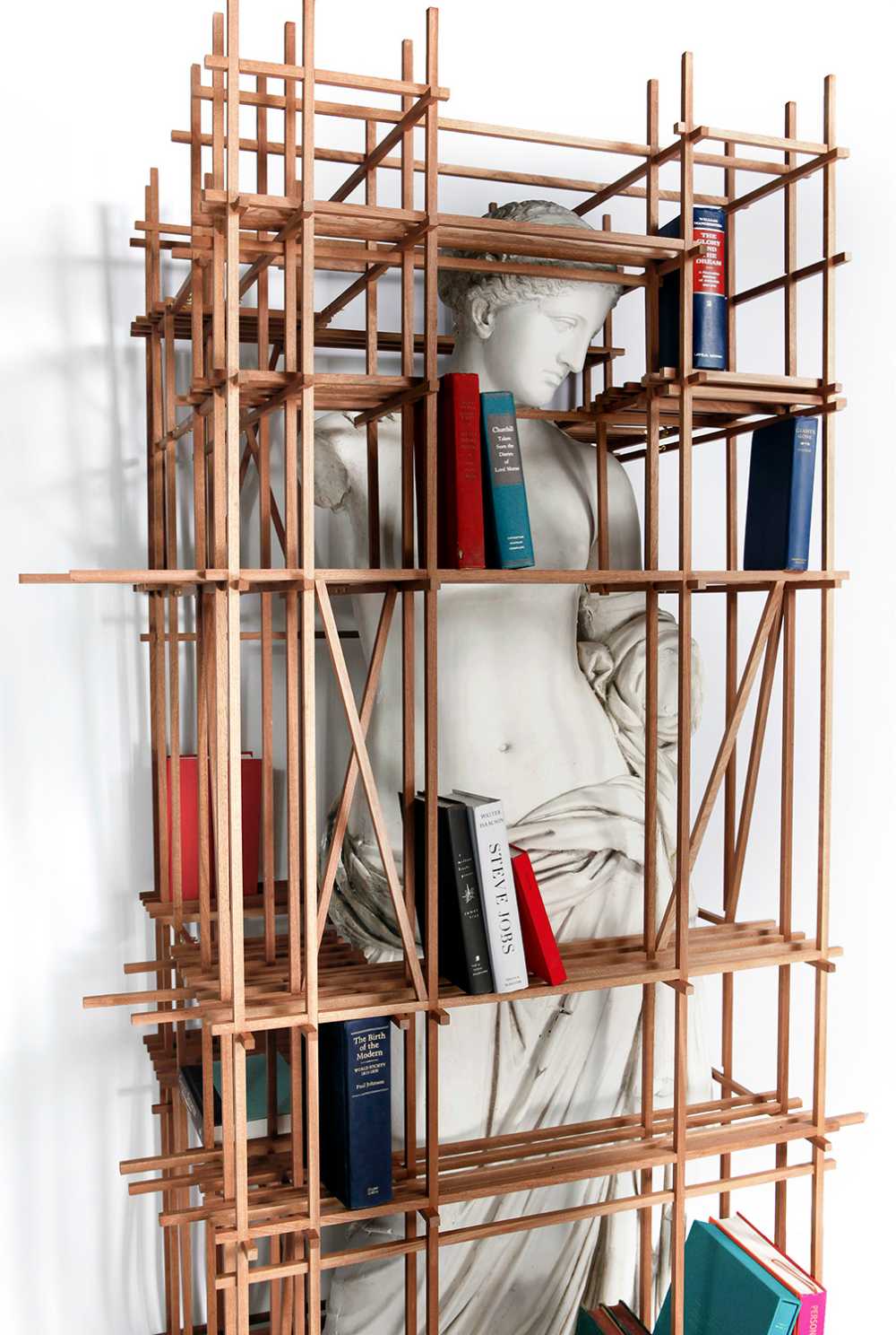 The bookcase envelops the work of art