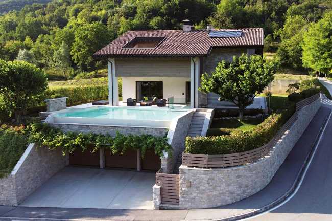 Contemporary stone rebuilt villa: dialogue between nature and design