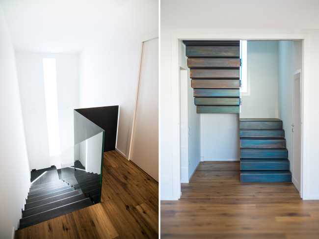 Corpo scala e pavimento in legno in contrasto con le bianche pareti