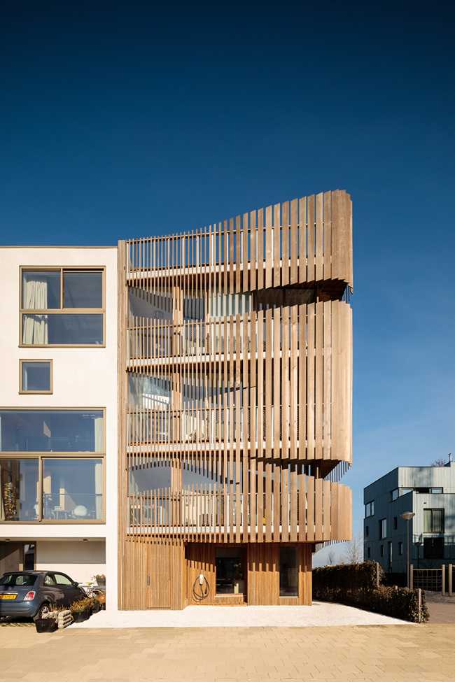 design-building-residence-complex-slats-wood-organic-construction-nature-sun-movement-privacy-exterior-detail-facade