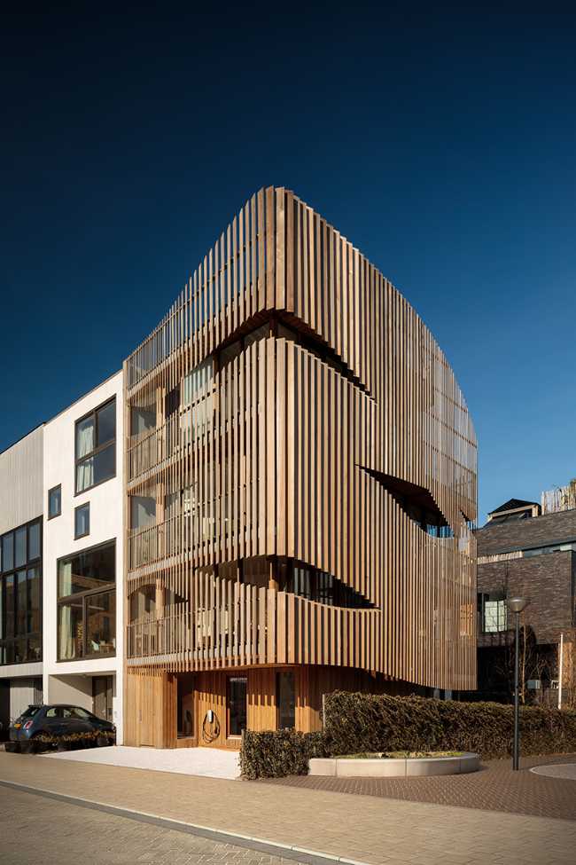 design-building-residence-complex-slats-wood-organic-construction-nature-sun-movement-privacy-exterior-detail-facade-side