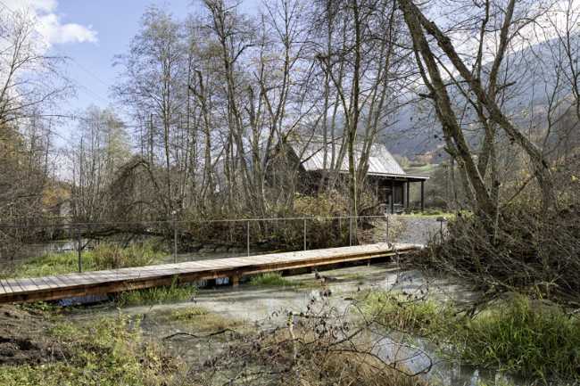 Vista del edificio de madera rodeado de naturaleza y paisajes suizos