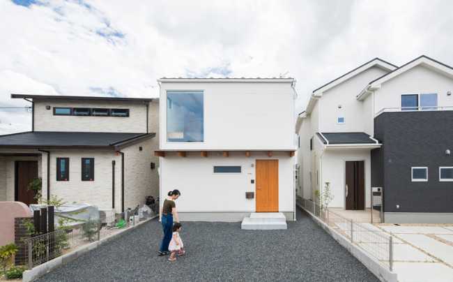 White exterior with wooden entrance door