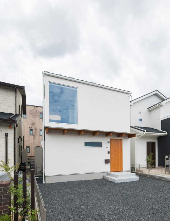 White facade with glass door and wooden door