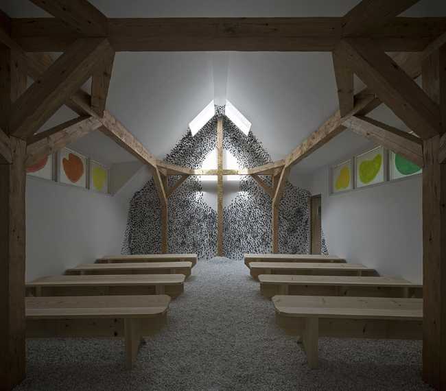 Wooden cross inside the Chapel at the Venice Biennale covered in gold leaves