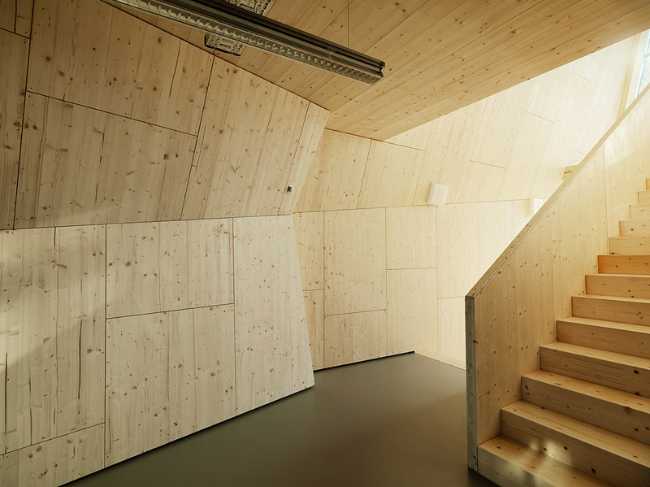 Spruce office building interior with wooden staircase