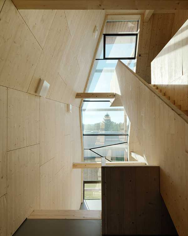 Interior of spruce building with bay window and landscape view
