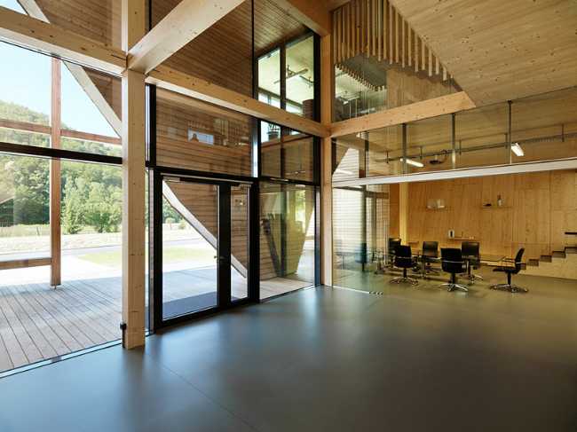 Interior of the office building with large glass windows opening onto the landscape