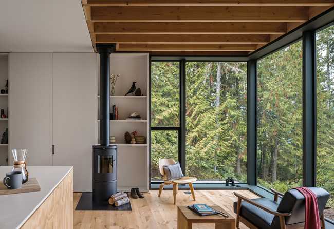 Interior in wood with window on the landscape