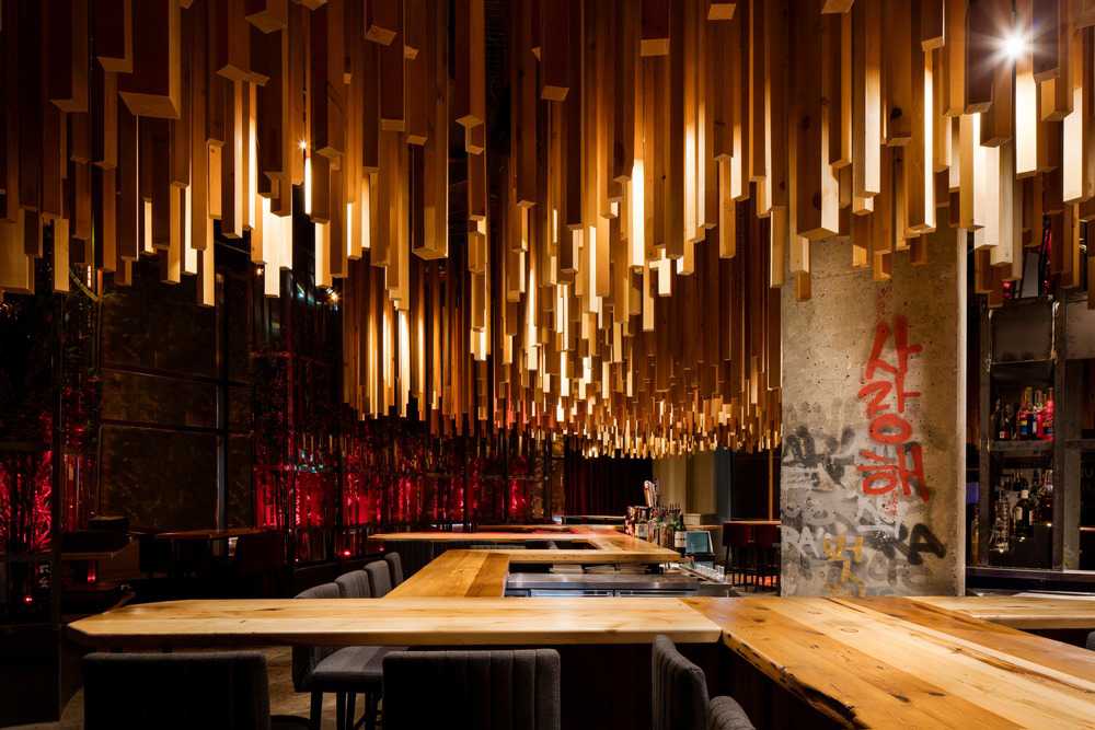 Barra de bar con piezas de madera suspendidas