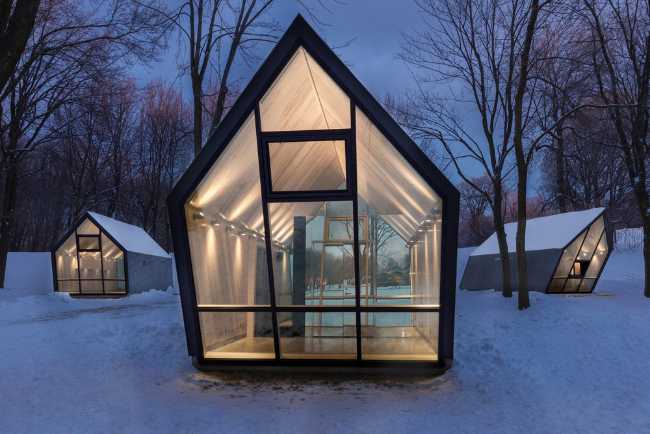 Snow-covered kiosks with internal lighting