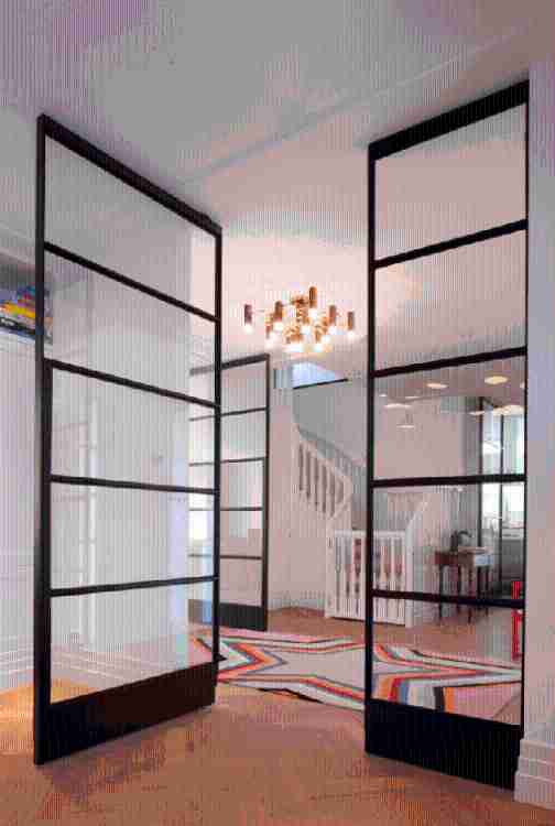 Fritsjurgens glazed door with black full-height profiles with a retractable hinge rotating on a vertical axis