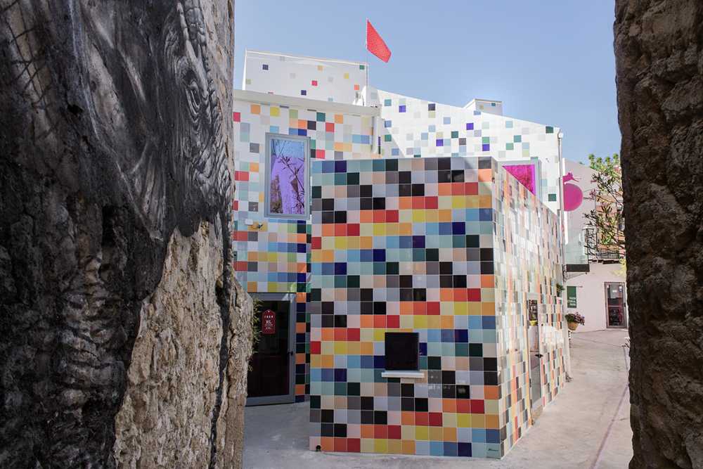 alley and facades of the houses painted with graphics