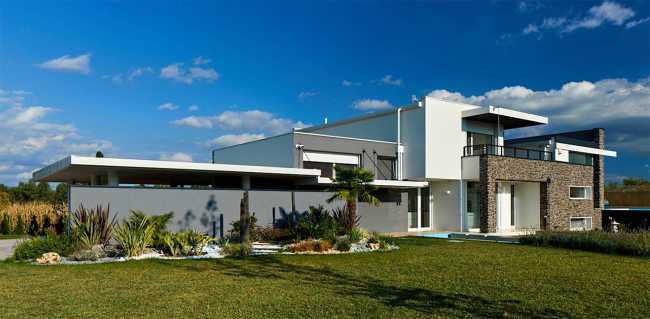 Stone villa surrounded by cultivated fields
