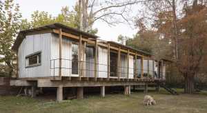 House Dique Luján traditional wooden construction on the banks of the river