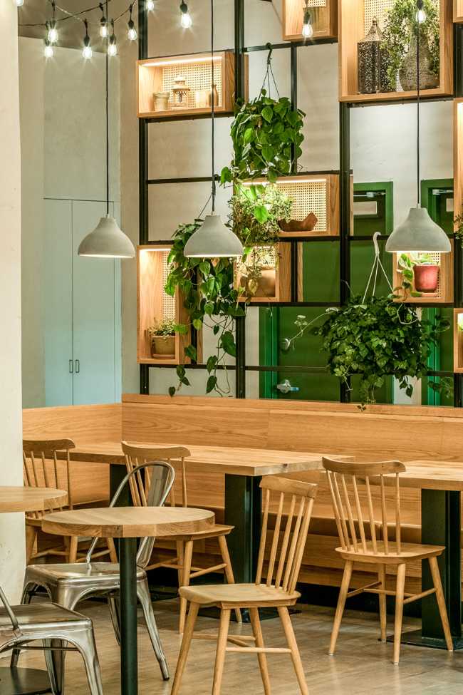 Interior of a restaurant in grey, wood and green