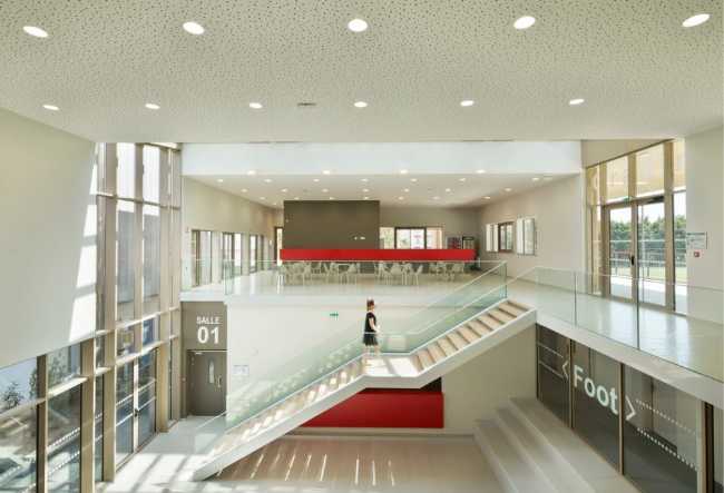 Double-height minimal sports center interior