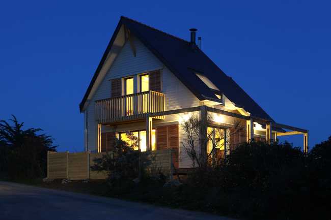 Illuminated gabled wooden house