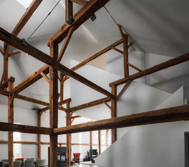 White volumes and exposed wooden structure