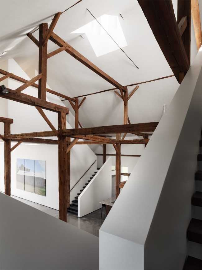 White volumes and exposed wooden structure