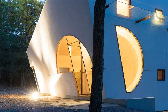 Wooden house lighting in the woods