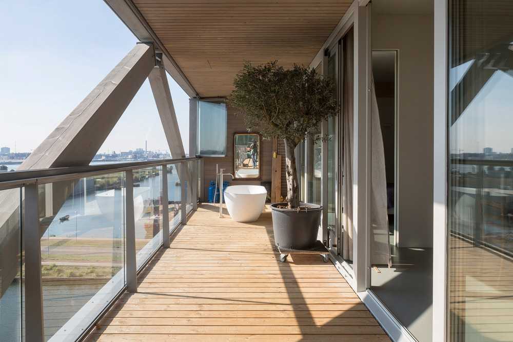 Wooden terrace with windows with white shutters