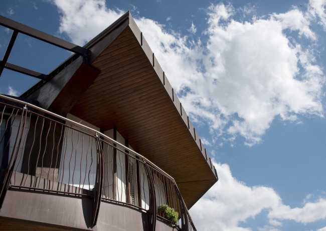 House in wood and metal in contrast with the sky