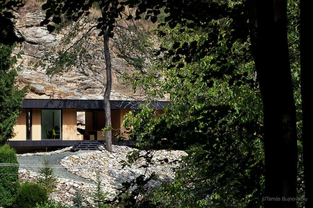 Dark and light wooden villa on the rock