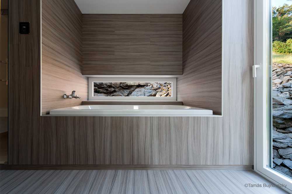 Dark and light wooden villa on the rock
