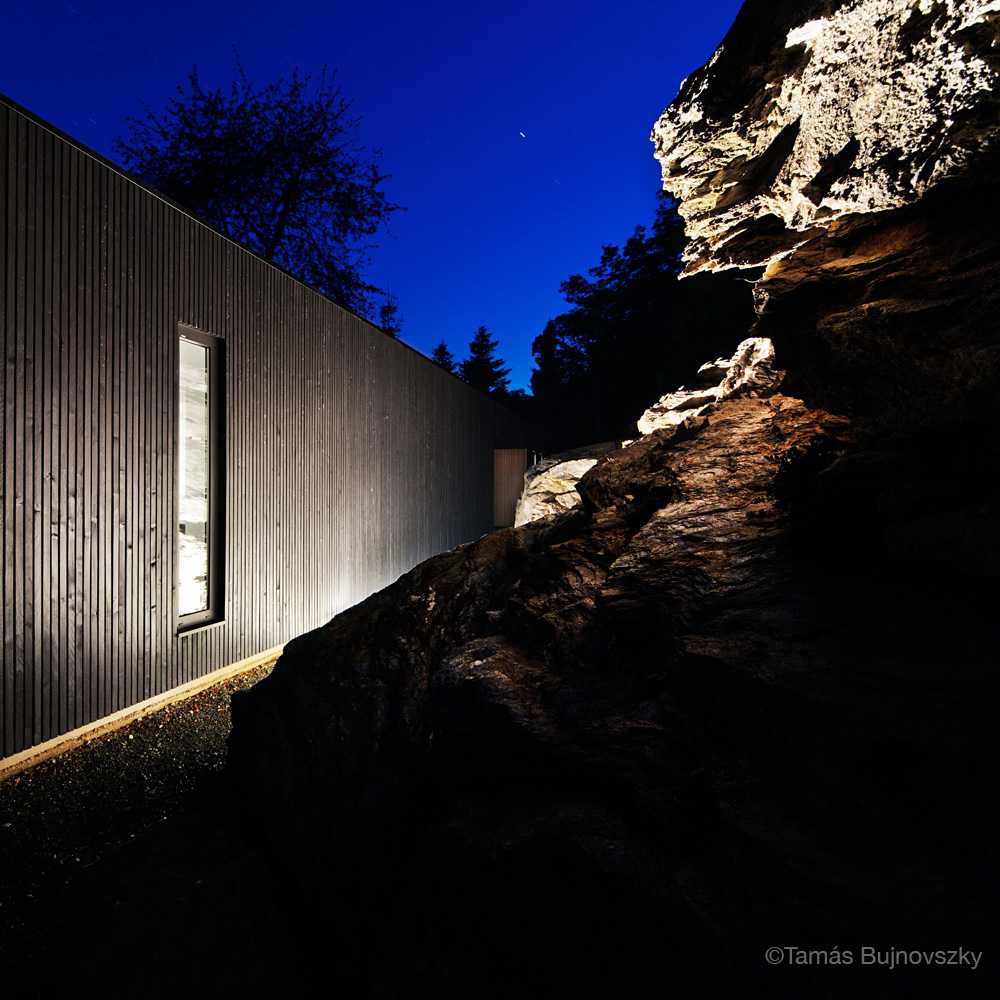 Dark and light wooden villa on the rock