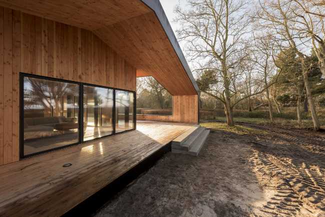 Wooden house in the trees with bay window