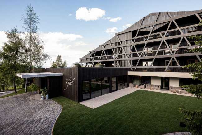 Outdoor space and wooden facade of the hotel