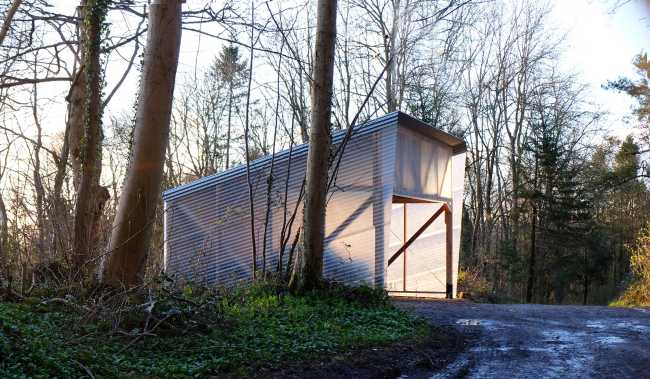 Laboratory among the trees with wooden structure and transparent walls fiberglass corrugated steel