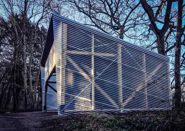 Laboratory among the trees with wooden structure and walls in corrugated steel
