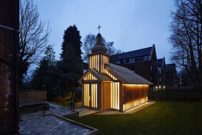 Illuminated wooden chapel at night